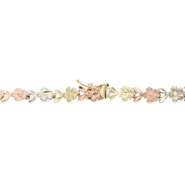 Pulsera eslabón articulado motivo flores en oro tres tonos 14 kilates.