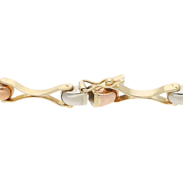 Pulsera eslabón articulado en oro tres tonos 14 kilates.