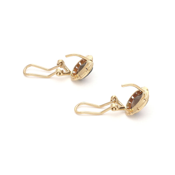 Juego anillo y aretes calados con topacios en oro amarillo 14 kilates.