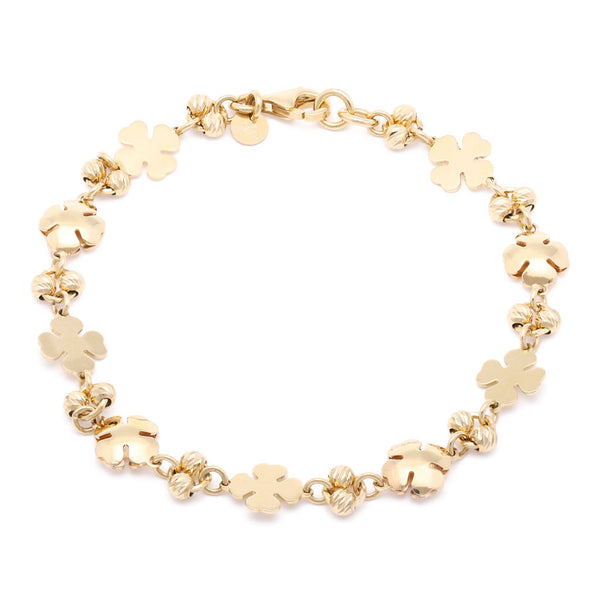 Pulsera eslabón combinado Motivo tréboles en oro amarillo 14 kilates.