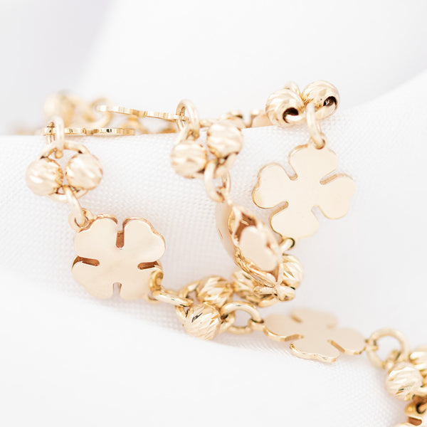 Pulsera eslabón combinado Motivo tréboles en oro amarillo 14 kilates.