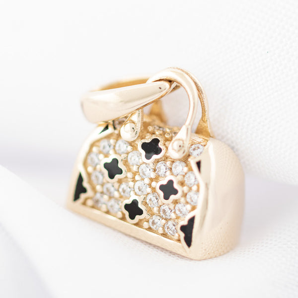 Dije diseño especial con circonias y esmalte motivo bolso en oro amarillo 14 kilates.