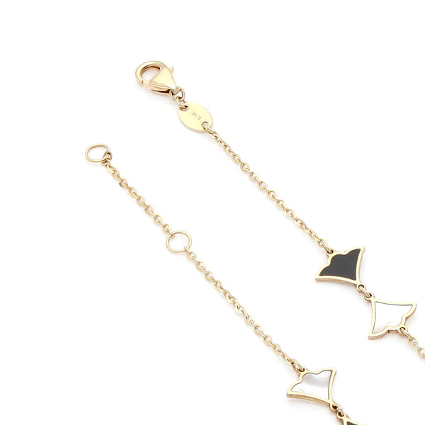 Pulsera eslabón cruzado con aplicaciones motivo abanico con sintéticos en oro amarillo 14 kilates.