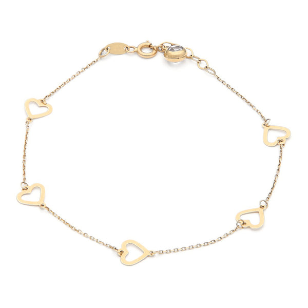 Pulsera eslabón cruzado con aplicaciones motivo corazón y sintético en oro amarillo 14 kilates.