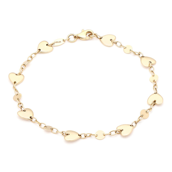 Pulsera eslabón cruzado con aplicaciones motivo corazón en oro amarillo 14 kilates.