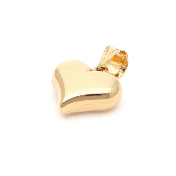 Dije hueco motivo corazón en oro amarillo 14 kilates.