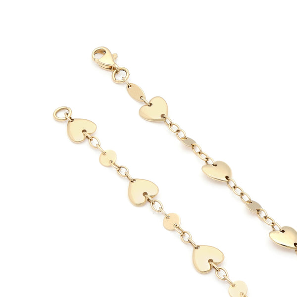 Pulsera eslabón cruzado con aplicaciones de corazón en oro amarillo 14 kilates.