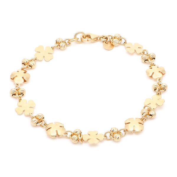 Pulsera eslabón combinado con aplicaciones motivo trébol en oro amarillo 14 kilates.