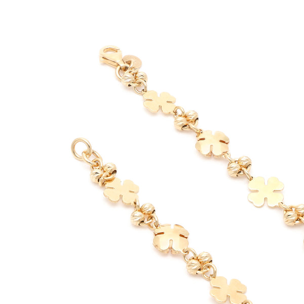Pulsera eslabón combinado con aplicaciones motivo trébol en oro amarillo 14 kilates.