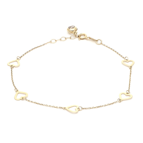 Pulsera eslabón cruzado con aplicaciones motivo corazón y sintético en oro amarillo 14 kilates.