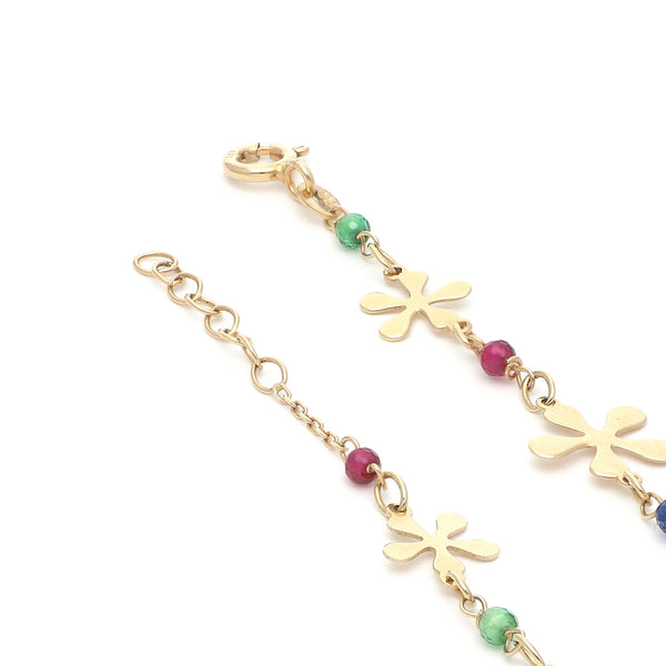 Pulsera eslabón combinado con aplicaciones motivo flor y sintéticos en oro amarillo 14 kilates.