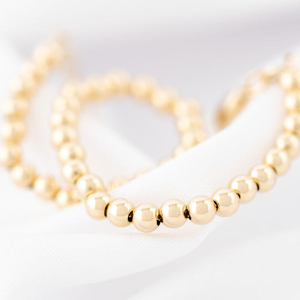 Pulsera eslabón boleado en oro amarillo 14 kilates.