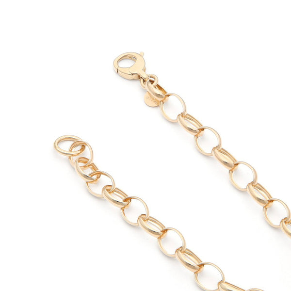 Pulsera eslabón cruzado con colgantes motivo candado y llave en oro amarillo 14 kilates.