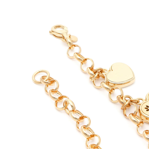 Pulsera eslabón cruzado con colgantes motivo corazón en oro amarillo 14 kilates.