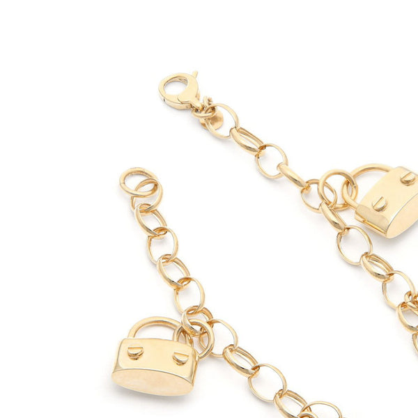 Pulsera eslabón cruzado colgantes motivo llave y candado en oro amarillo 14 kilates.