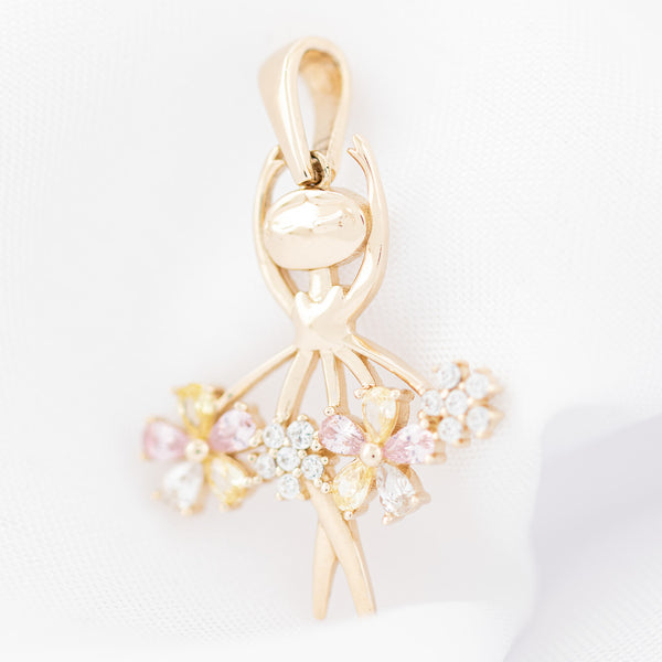 Dije diseño especial motivo bailarina con sintéticos en oro amarillo 14 kilates.