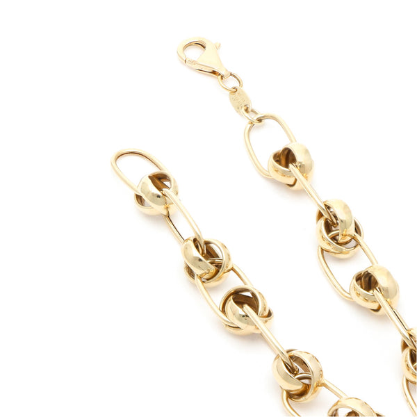 Pulsera eslabón cruzado con aplicaciones en oro amarillo 14 kilates.