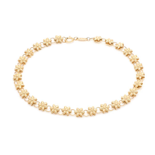 Pulsera eslabón combinado motivo flor en oro amarillo 14 kilates.