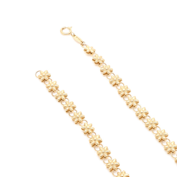 Pulsera eslabón combinado motivo flor en oro amarillo 14 kilates.
