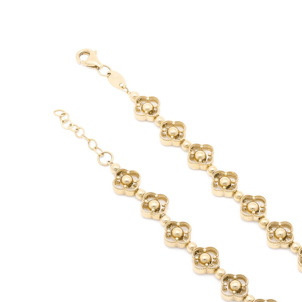 Pulsera eslabón articulado motivo flor en oro amarillo 14 kilates.