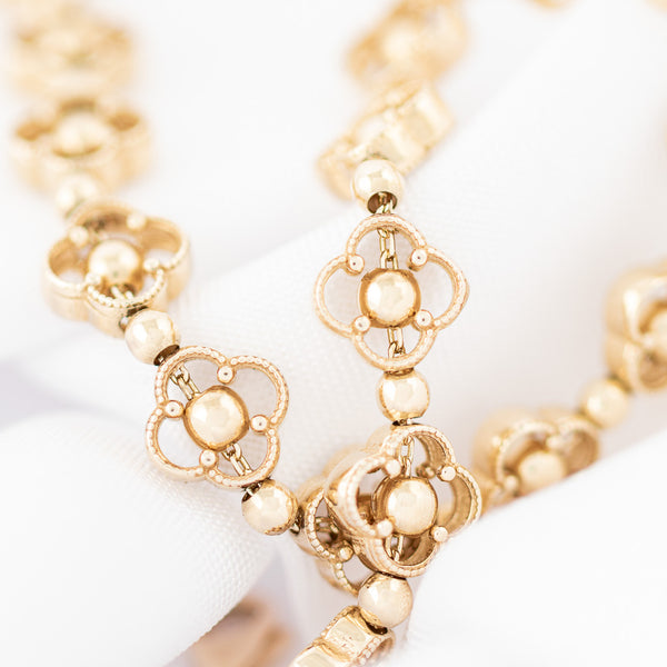 Pulsera eslabón articulado motivo flor en oro amarillo 14 kilates.