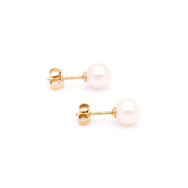 Aretes diseño especial con perlas en oro amarillo 14 kilates.