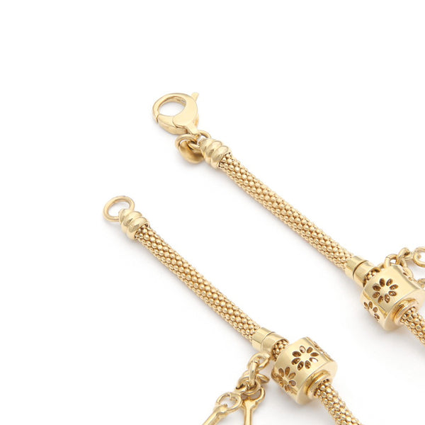 Pulsera eslabón tejido con aplicaciones y colgantes motivo llaves en oro amarillo 14 kilates.