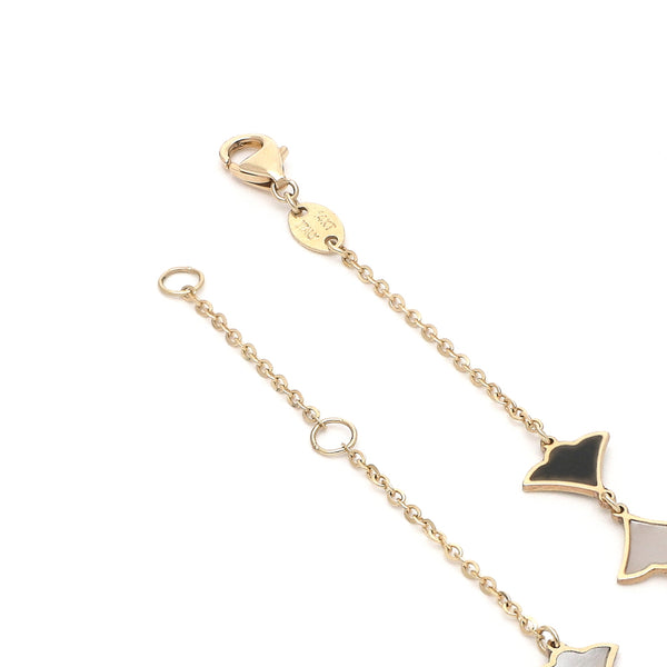Pulsera eslabón cruzado con aplicaciones y sintéticos motivo abanico en oro amarillo 14 kilates.