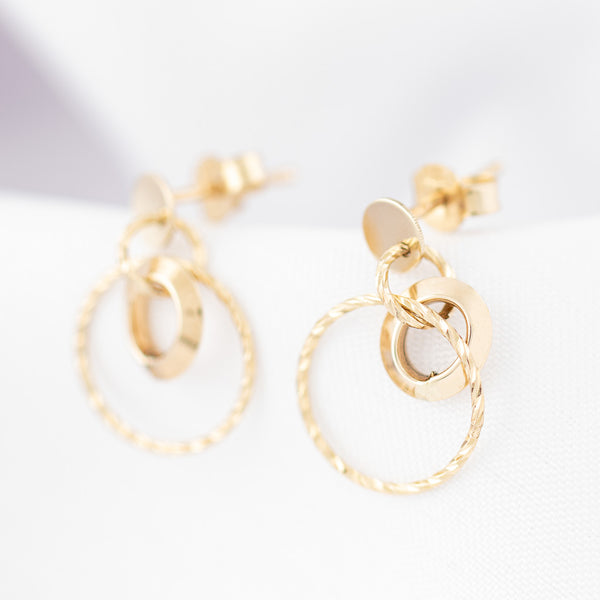 Aretes diseño especial con colgantes motivo aros en oro amarillo 14 kilates.