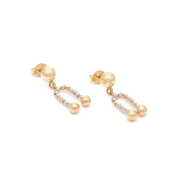 Aretes boleados con colgantes en oro dos tonos 14 kilates.