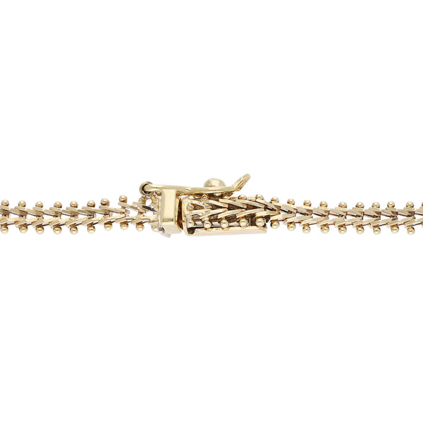 Pulsera eslabón boleado con aplicaciones en oro amarillo 14 kilates.