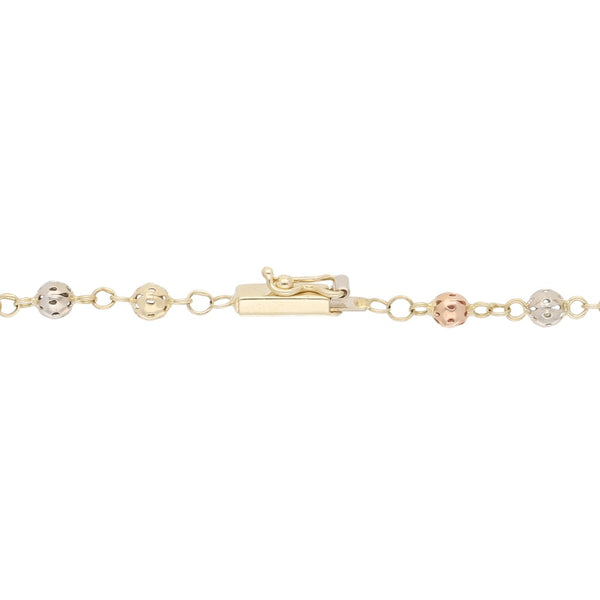 Pulsera tipo rosario eslabón cruzado aplicaciones de cuentas caladas y colgante de cruz en oro amarillo 14 kilates.