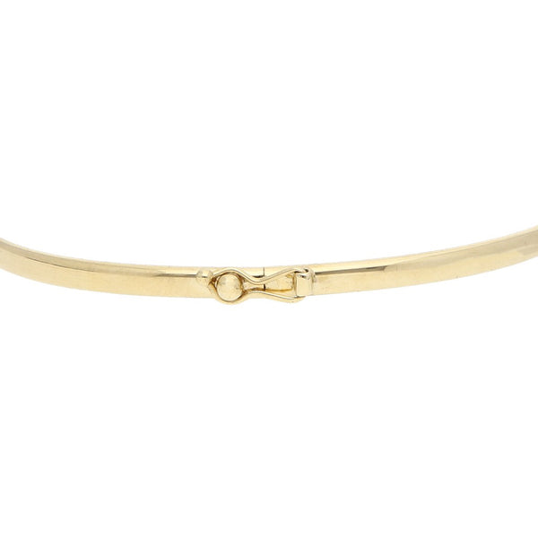 Pulsera de arillo lisa con aplicación motivo timón en oro tres tonos 14 kilates.