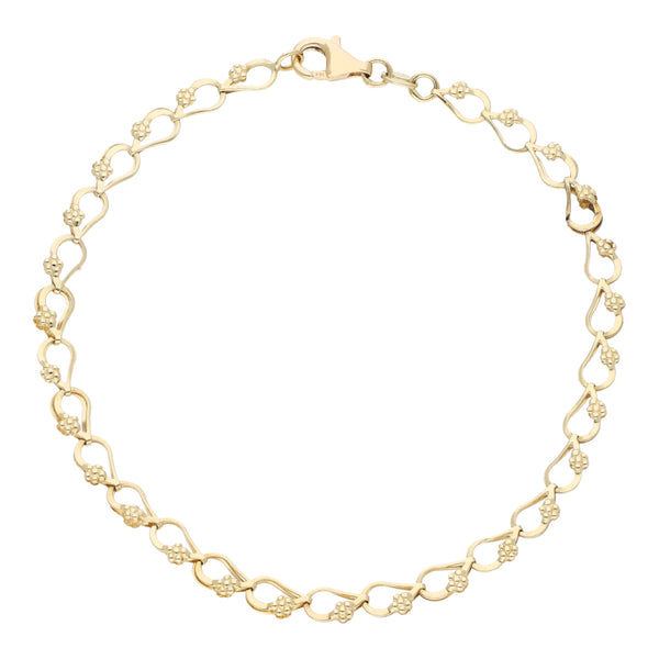 Pulsera eslabón laminado motivo flor en oro amarillo 14 kilates.