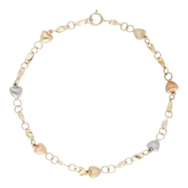 Pulsera eslabón combinado con aplicaciones motivo corazón en oro tres tonos 14 kilates.