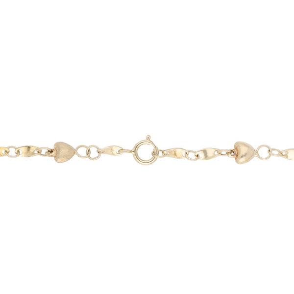 Pulsera eslabón combinado con aplicaciones motivo corazón en oro tres tonos 14 kilates.