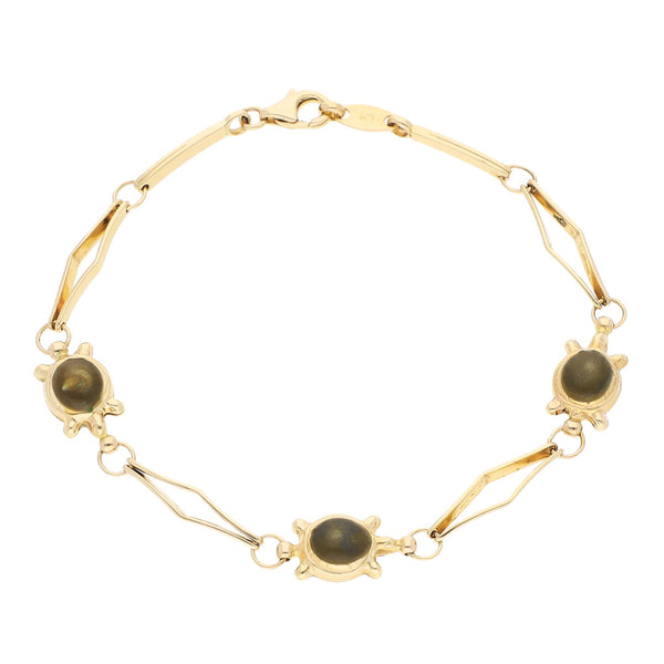 Pulsera eslabón articulado con aplicaciones motivo tortugas y gemas en oro amarillo 14 kilates.