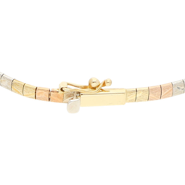 Pulsera eslabón articulado en oro tres tonos 14 kilates.