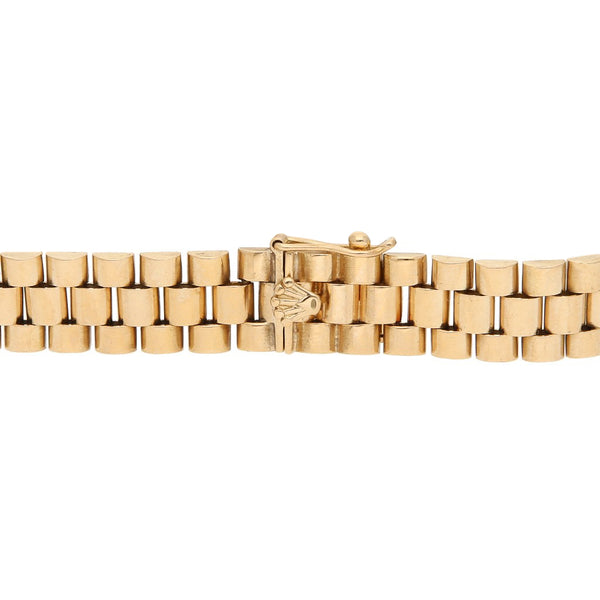 Pulsera eslabón articulado con aplicación motivo corona en oro amarillo 14 kilates