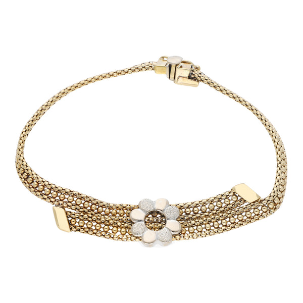 Pulsera de dos hilos eslabón boleado con aplicación motivo flor en oro dos tonos 14 kilates.