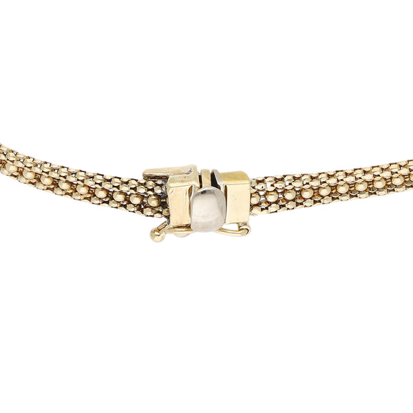 Pulsera de dos hilos eslabón boleado con aplicación motivo flor en oro dos tonos 14 kilates.