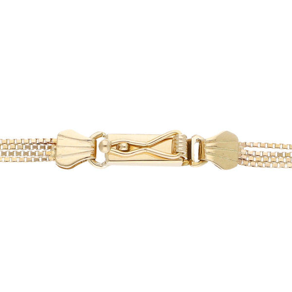 Esclava de cuatro hilos eslabón cuadrado cruzado con rubíes en oro amarillo 14 kilates.