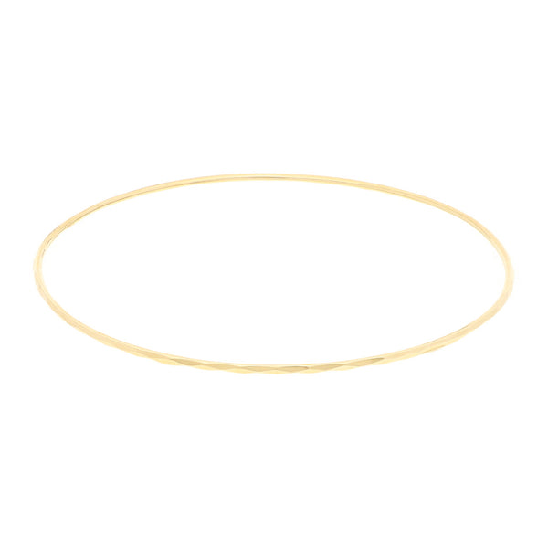 Pulsera de arillo facetada en oro amarillo 14 kilates.