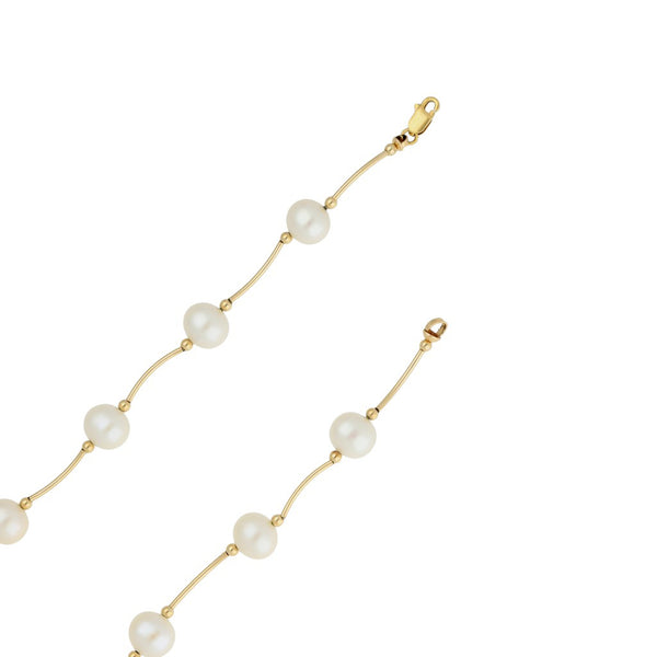 Juego de pulsera y gargantilla eslabón articulado con perlas en oro amarillo 14 kilates.