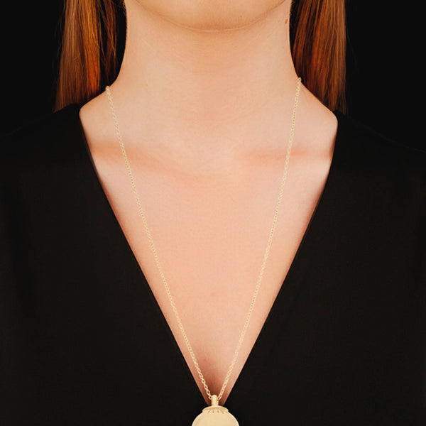 Collar eslabón cruzado con dije liso motivo esfera firma Tiffany & Co. en oro amarillo 18 kilates.