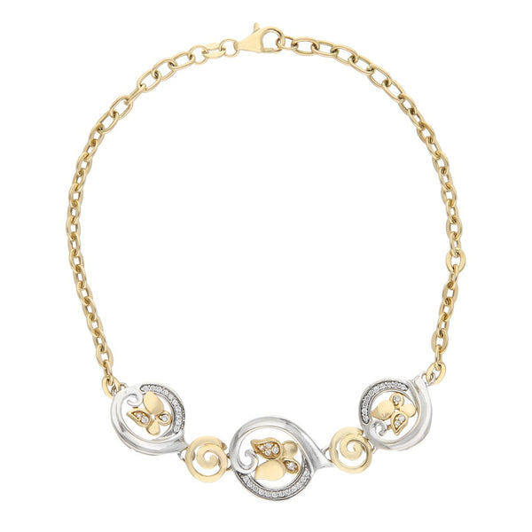 Pulsera eslabón cruzado con aplicaciones y circonias motivo mariposa en oro dos tonos.