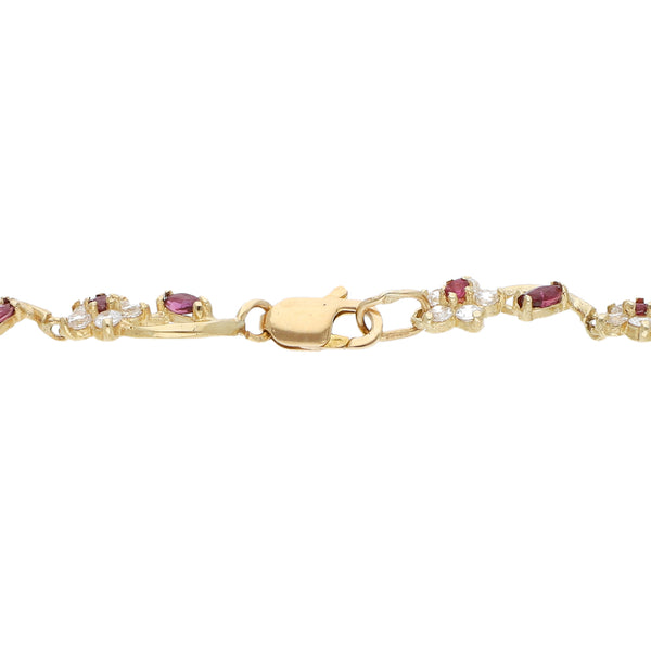 Pulsera eslabón articulado motivo flores con sintéticos en oro amarillo 12 kilates.