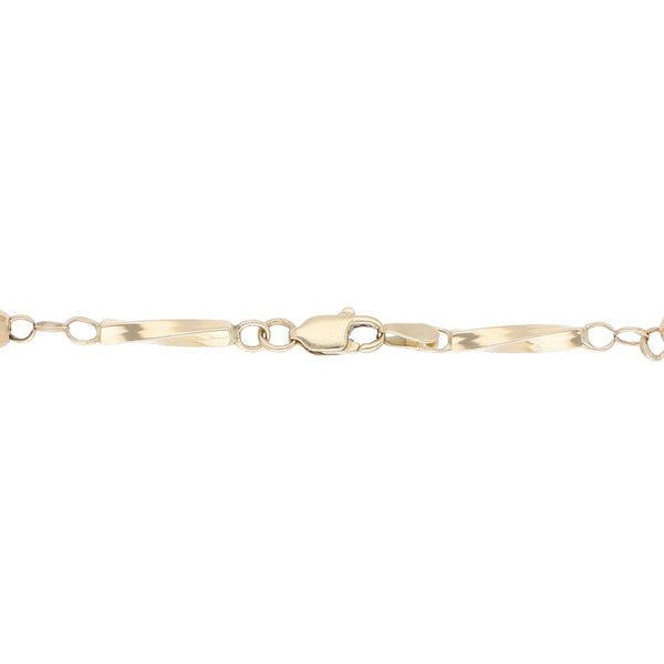 Pulsera eslabón articulado con aplicaciones motivo esferas en oro amarillo 14 kilates.