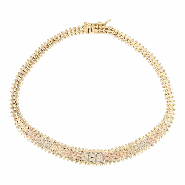 Pulsera boleada en oro tres tonos 14 kilates.