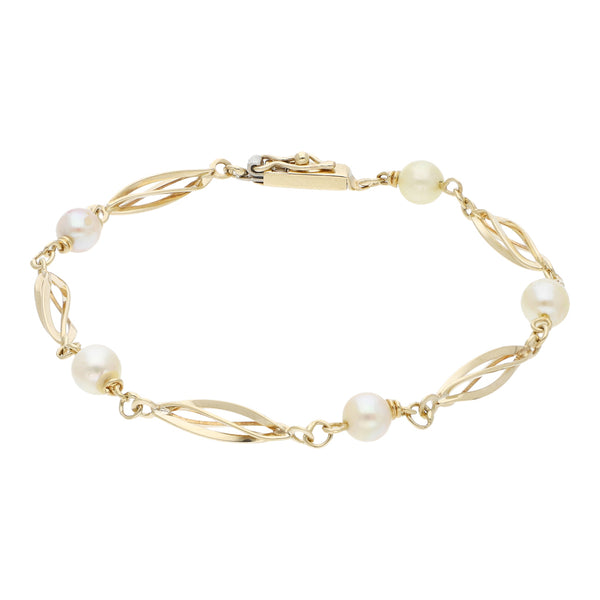 Pulsera eslabón articulado con aplicaciones de perlas en oro amarillo 14 kilates.